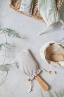 A neatly folded kessa glove next to natural Moroccan soap and argan oil bottles.