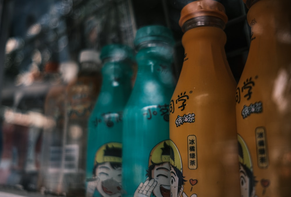 a row of colorful bottles sitting on top of a shelf