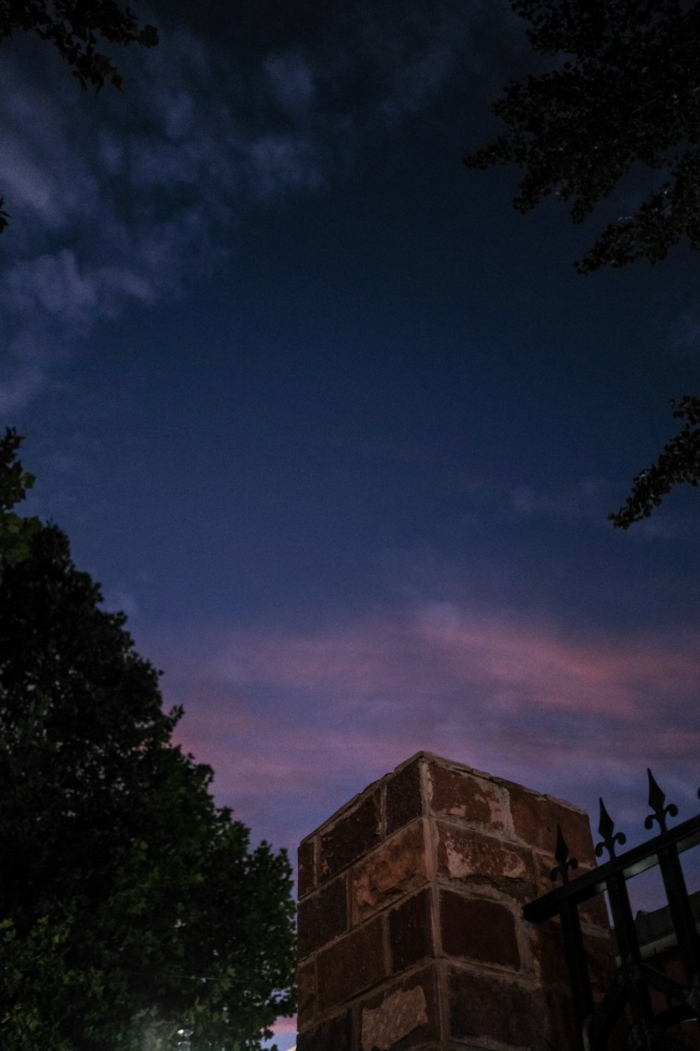 a tall brick structure sitting next to a tree