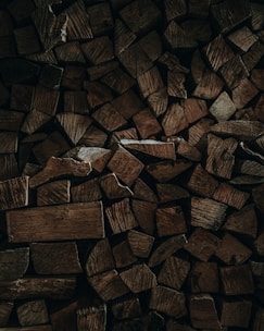 a pile of chopped wood sitting on top of a wooden floor