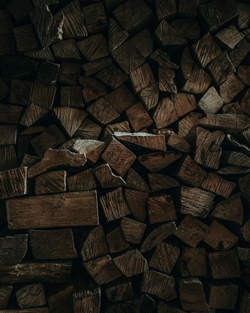 a pile of chopped wood sitting on top of a wooden floor