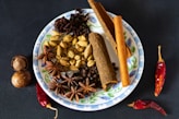 a plate with spices and nuts on it