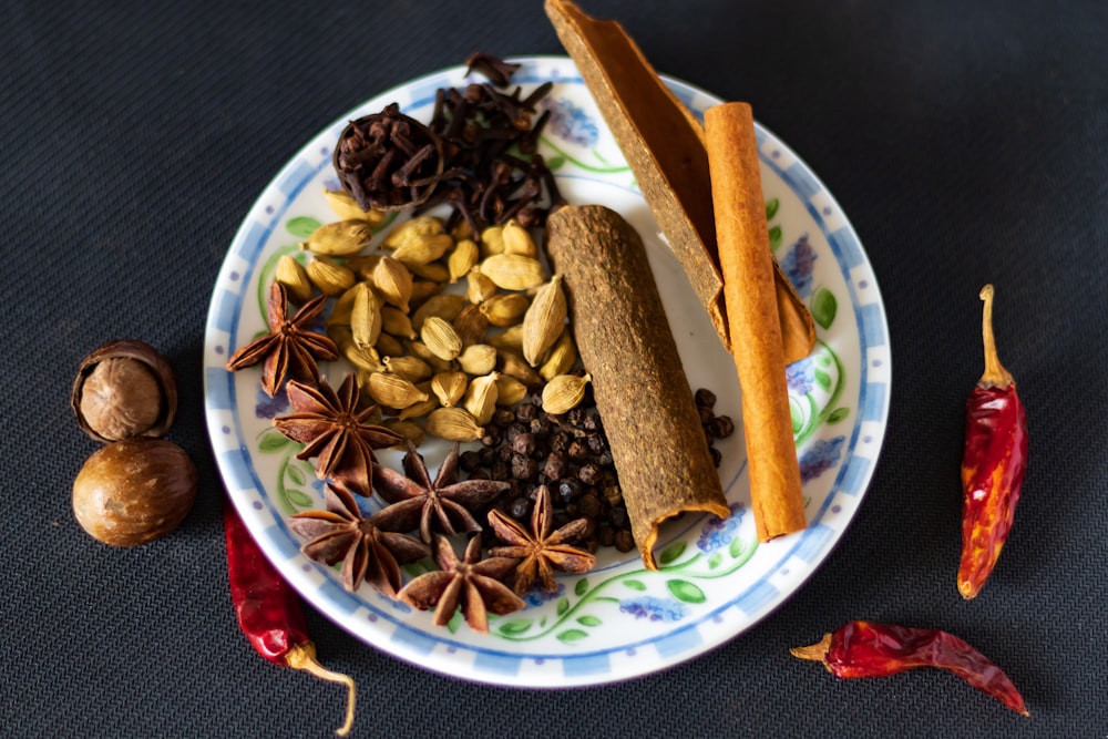 a plate with spices and nuts on it
