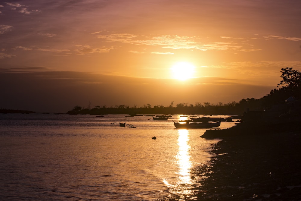 the sun is setting over a body of water