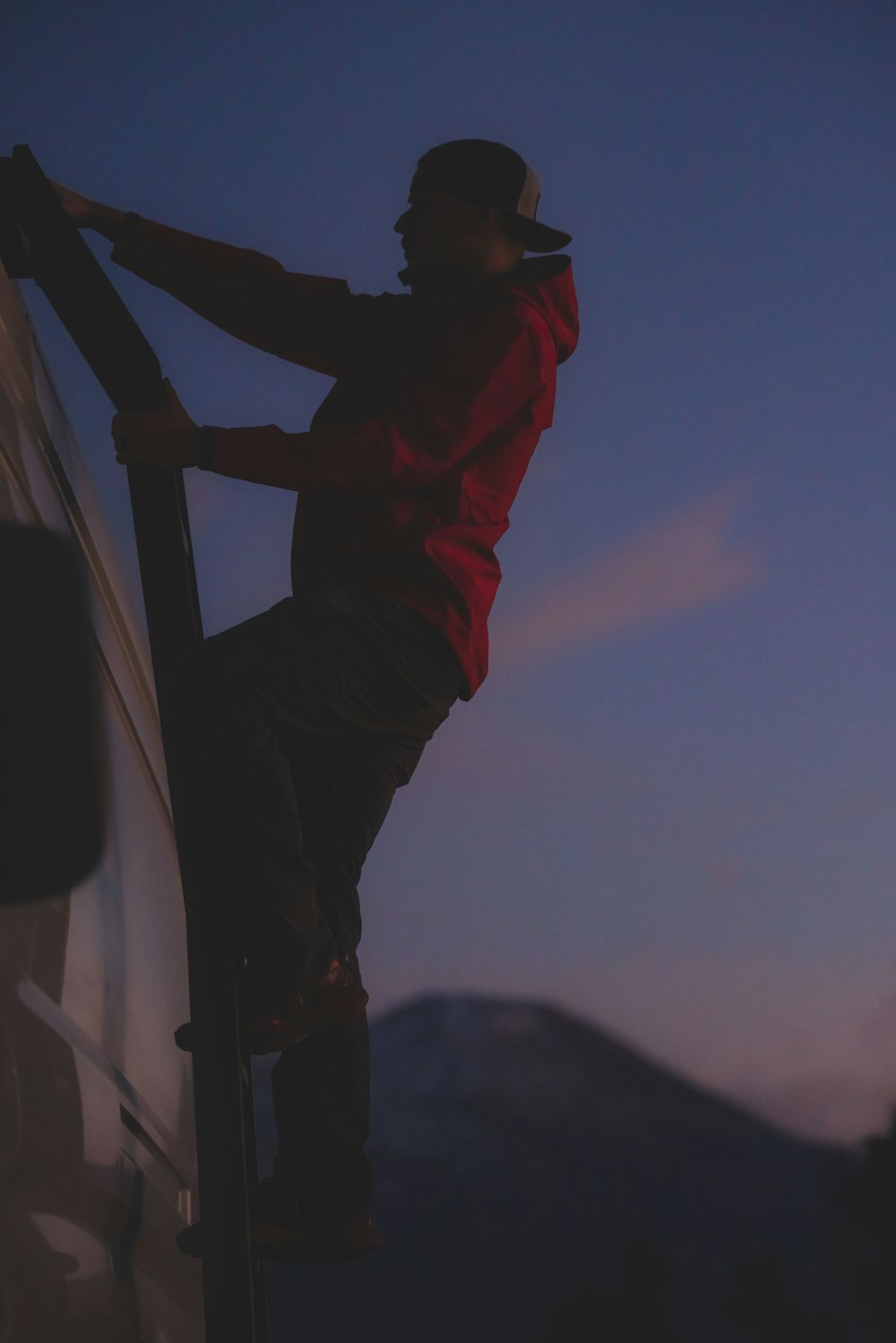 a man climbing up the side of a truck