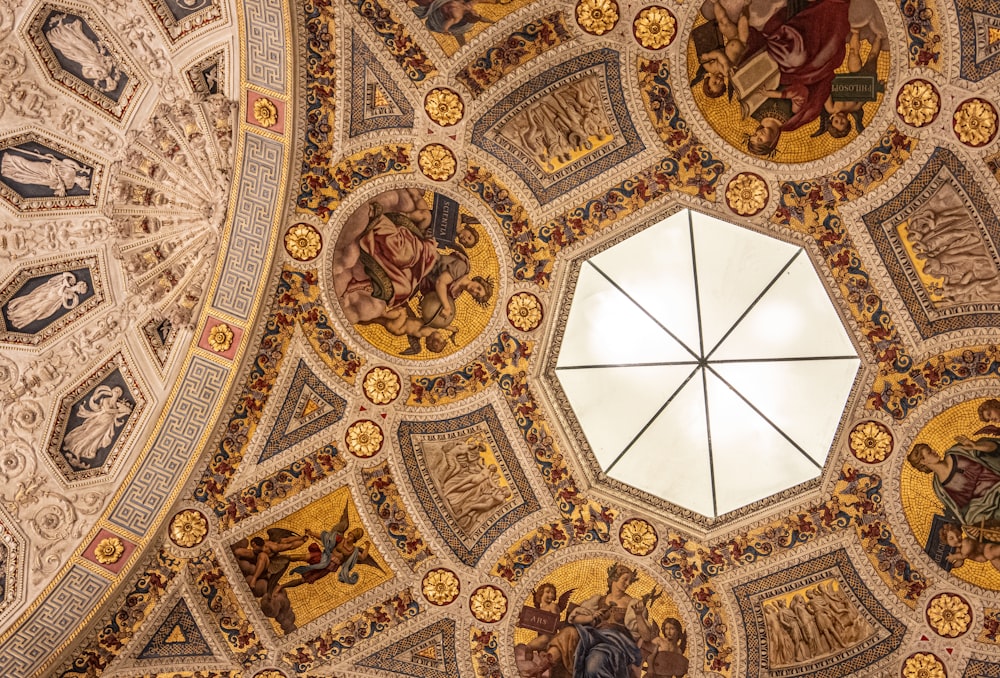 the ceiling of a building with paintings on it