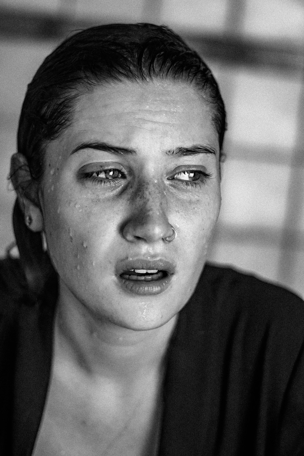 a black and white photo of a woman crying