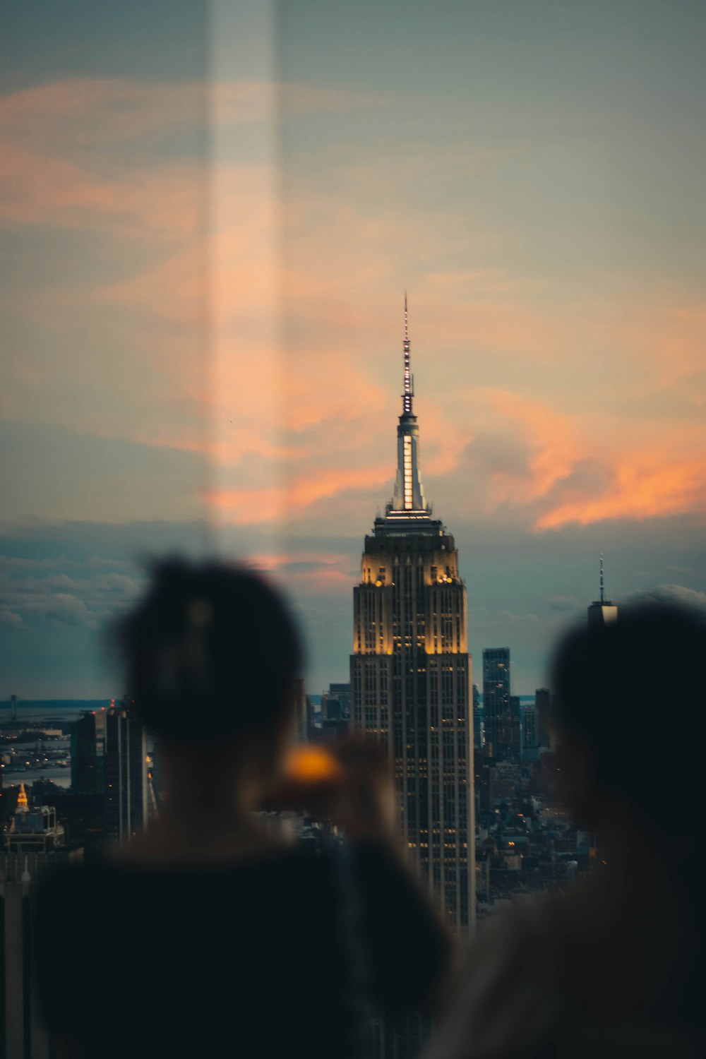 a couple of people standing in front of a tall building