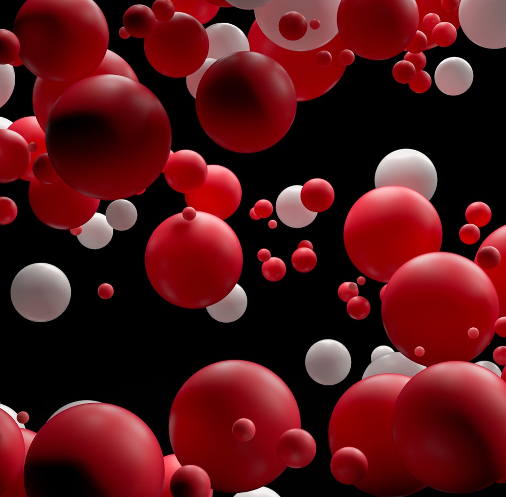 a bunch of red and white balls floating in the air