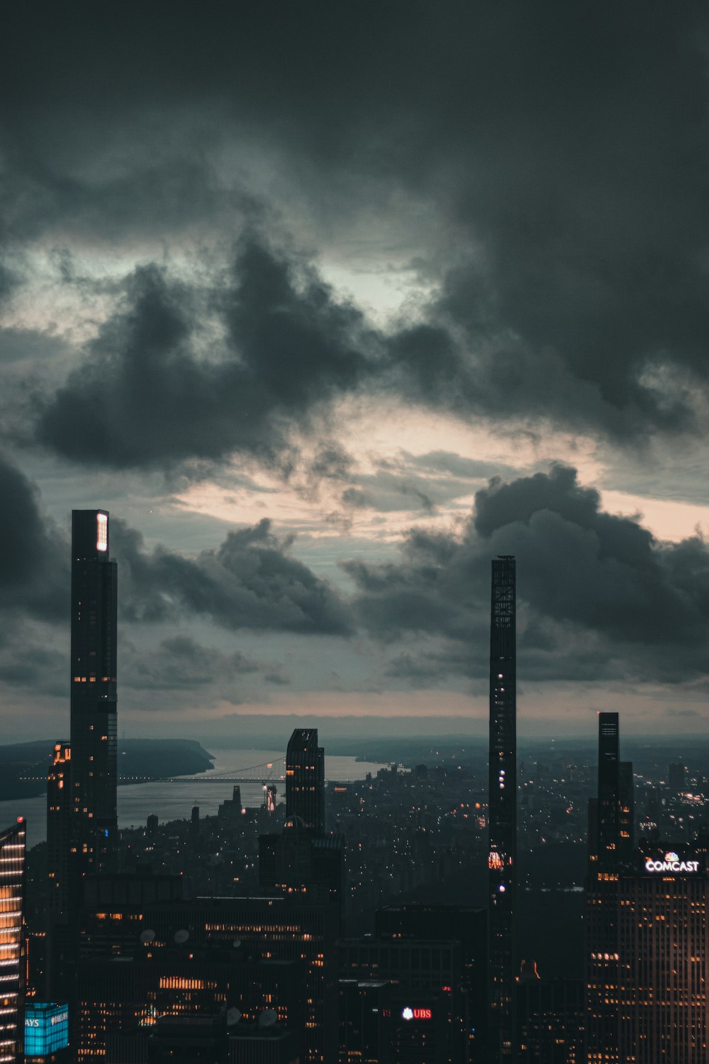 a view of a city at night with a cloudy sky