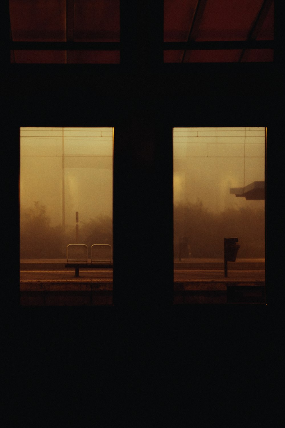 a view of a train station through two windows