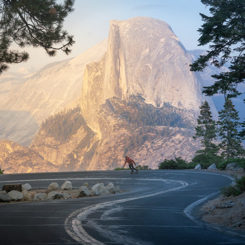 a person riding a bike down a winding road