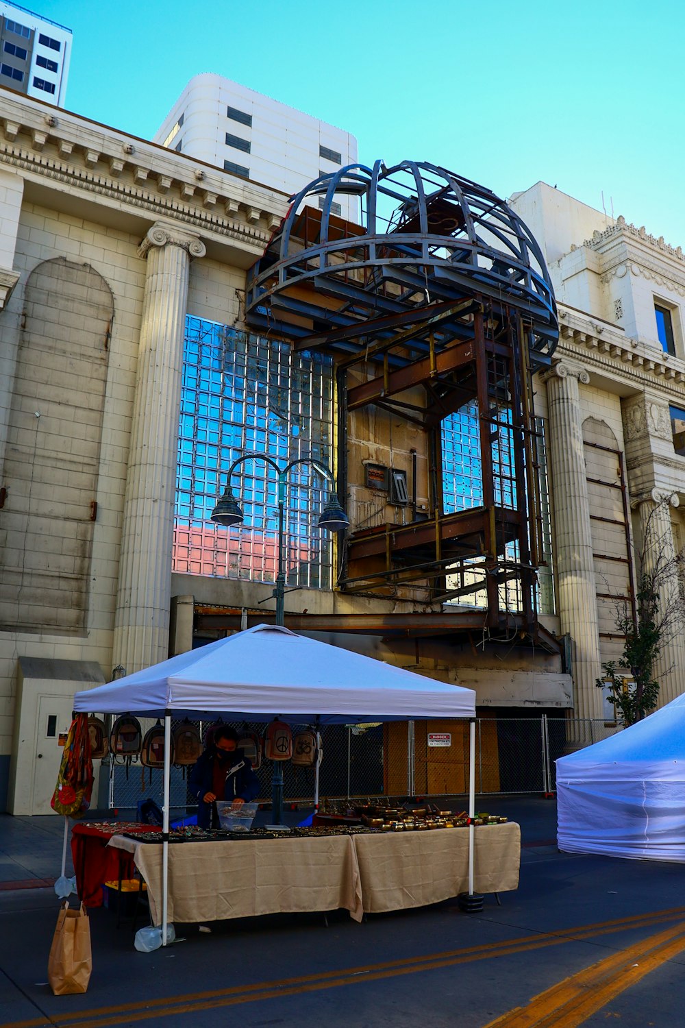 a large building that has a bunch of tables in front of it