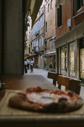 A cozy street scene in Paperino village with locals chatting near small shops.