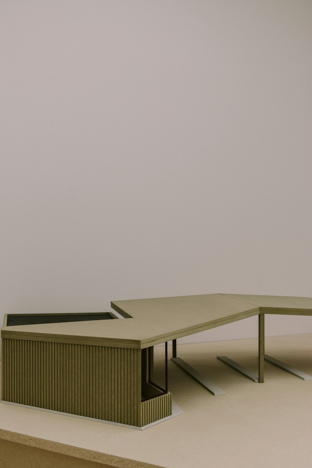 a model of a table and a bench in a room