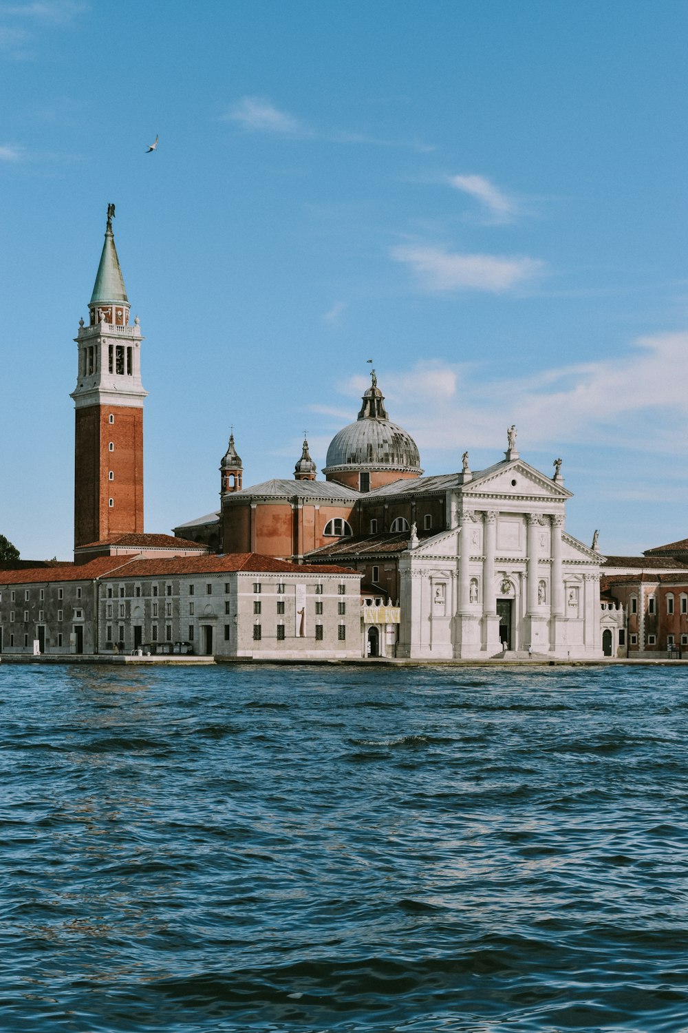 a large body of water with a building in the background