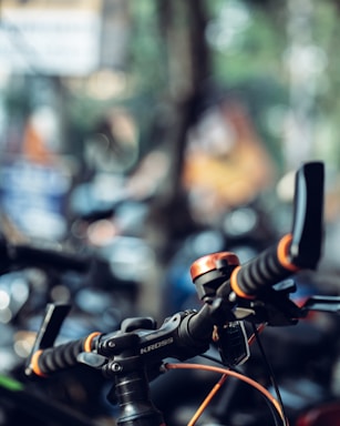 A sleek bicycle handlebar with elegant vaun accessories against a soft, inviting background.