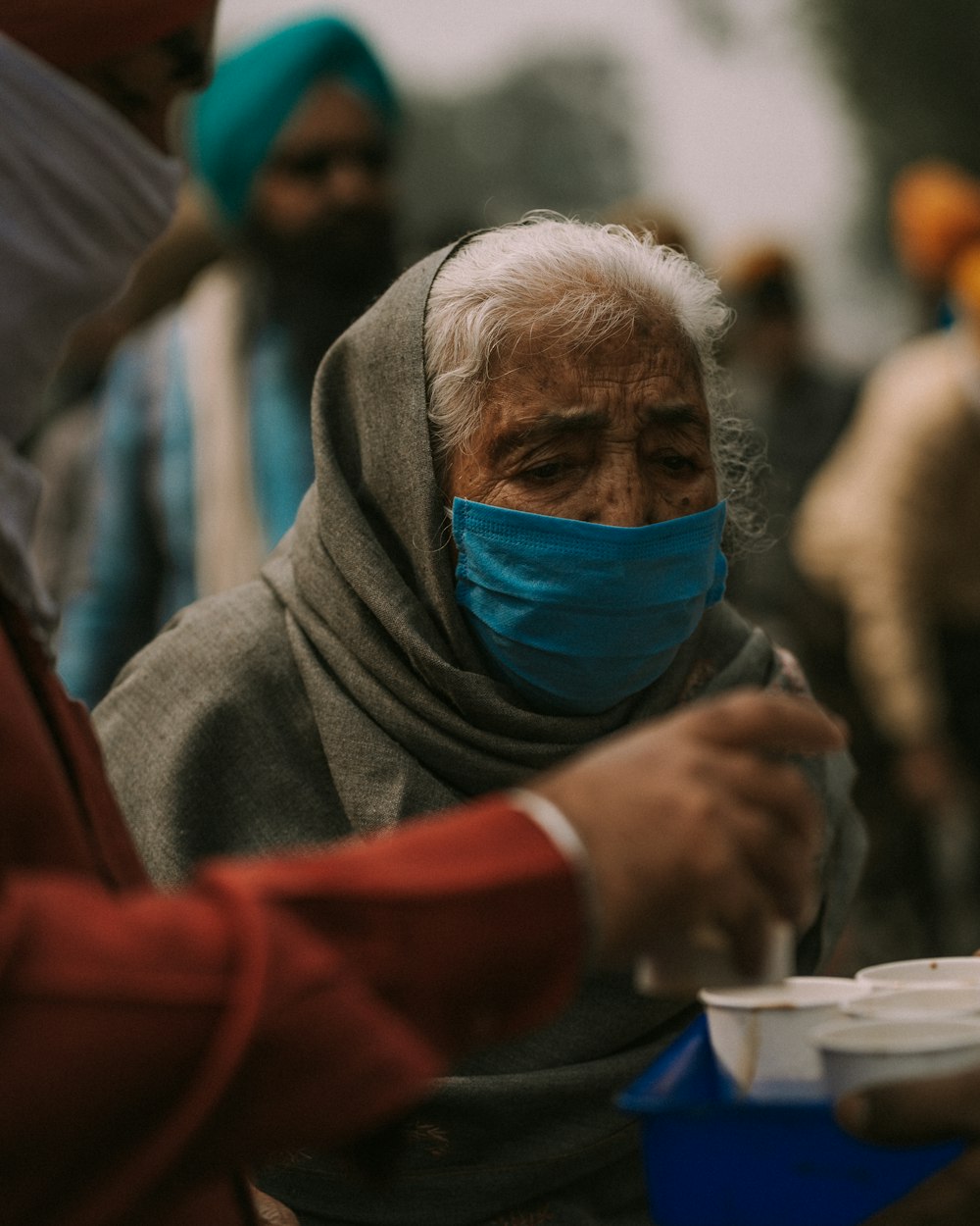 a woman wearing a face mask and eating food