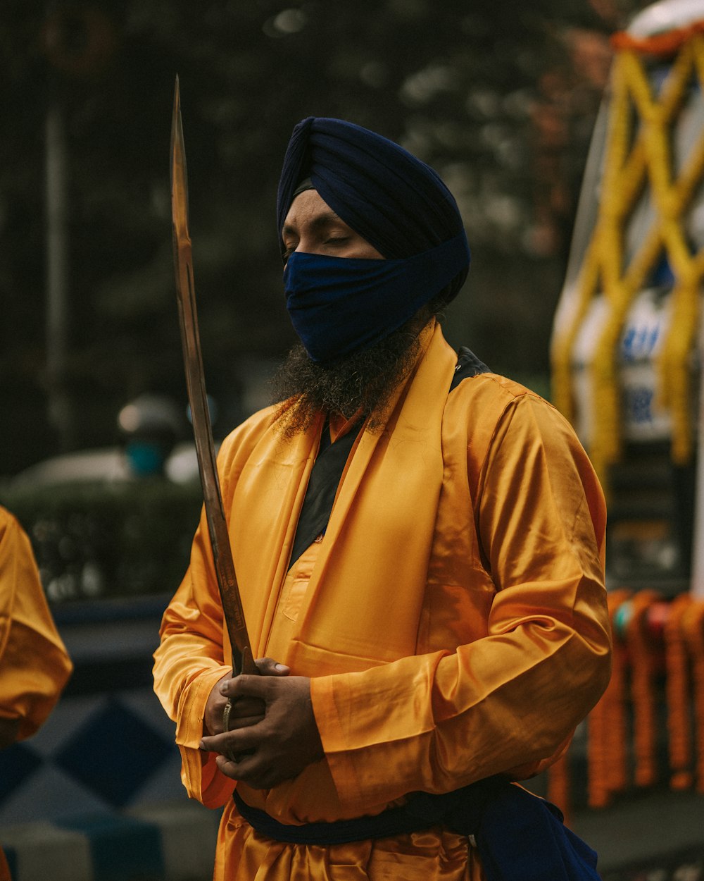 a man in a turban holding a sword