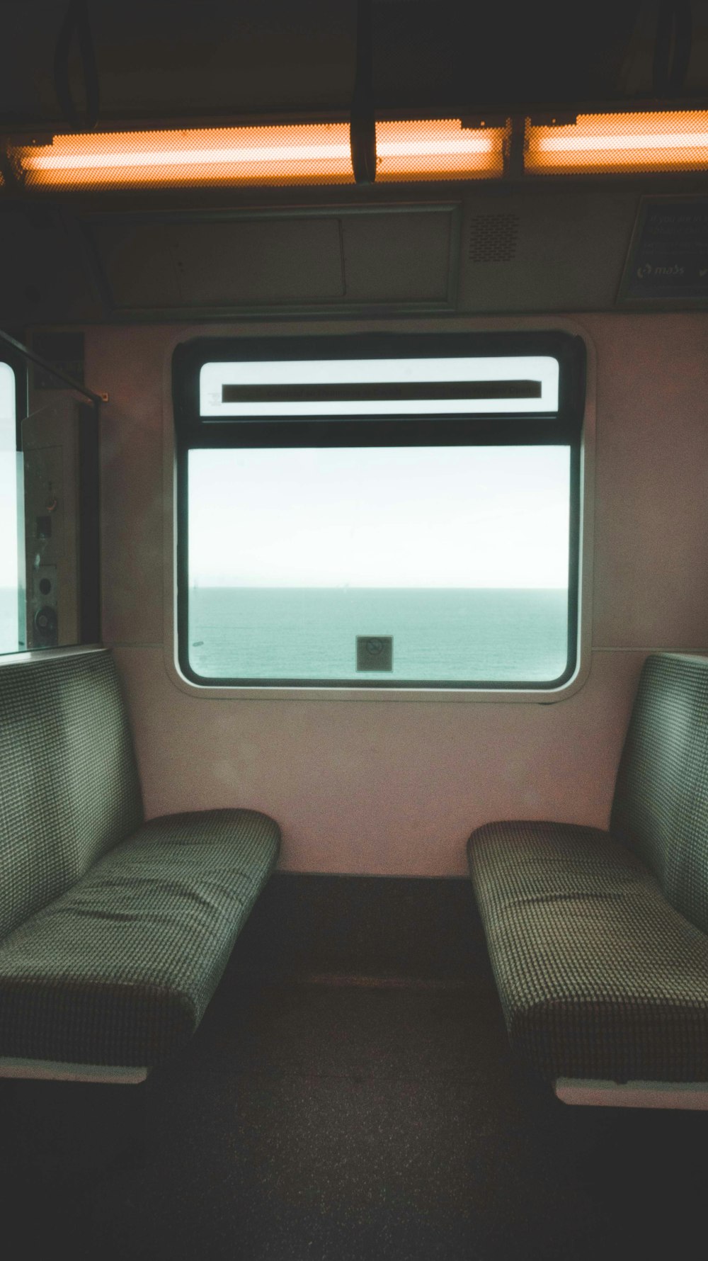 a train car with two seats and a window