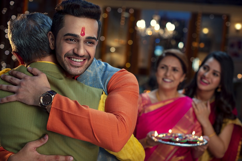 a man hugging a woman in front of other people