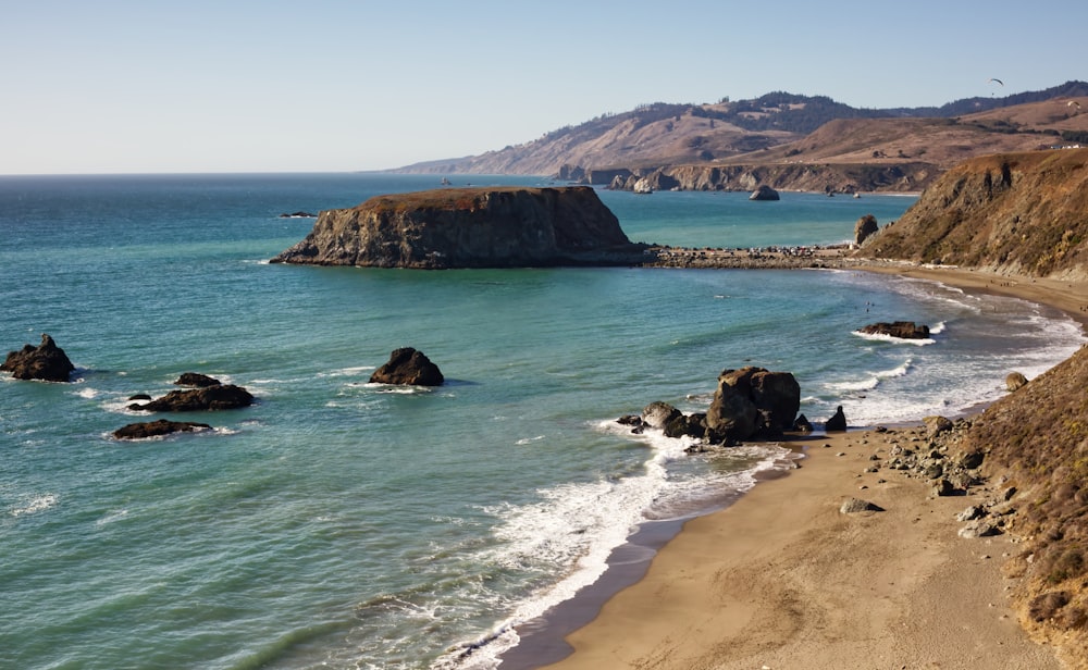 a view of a beach with a mountain in the background