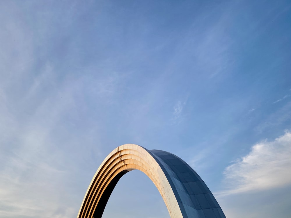 a large arch in the middle of a field