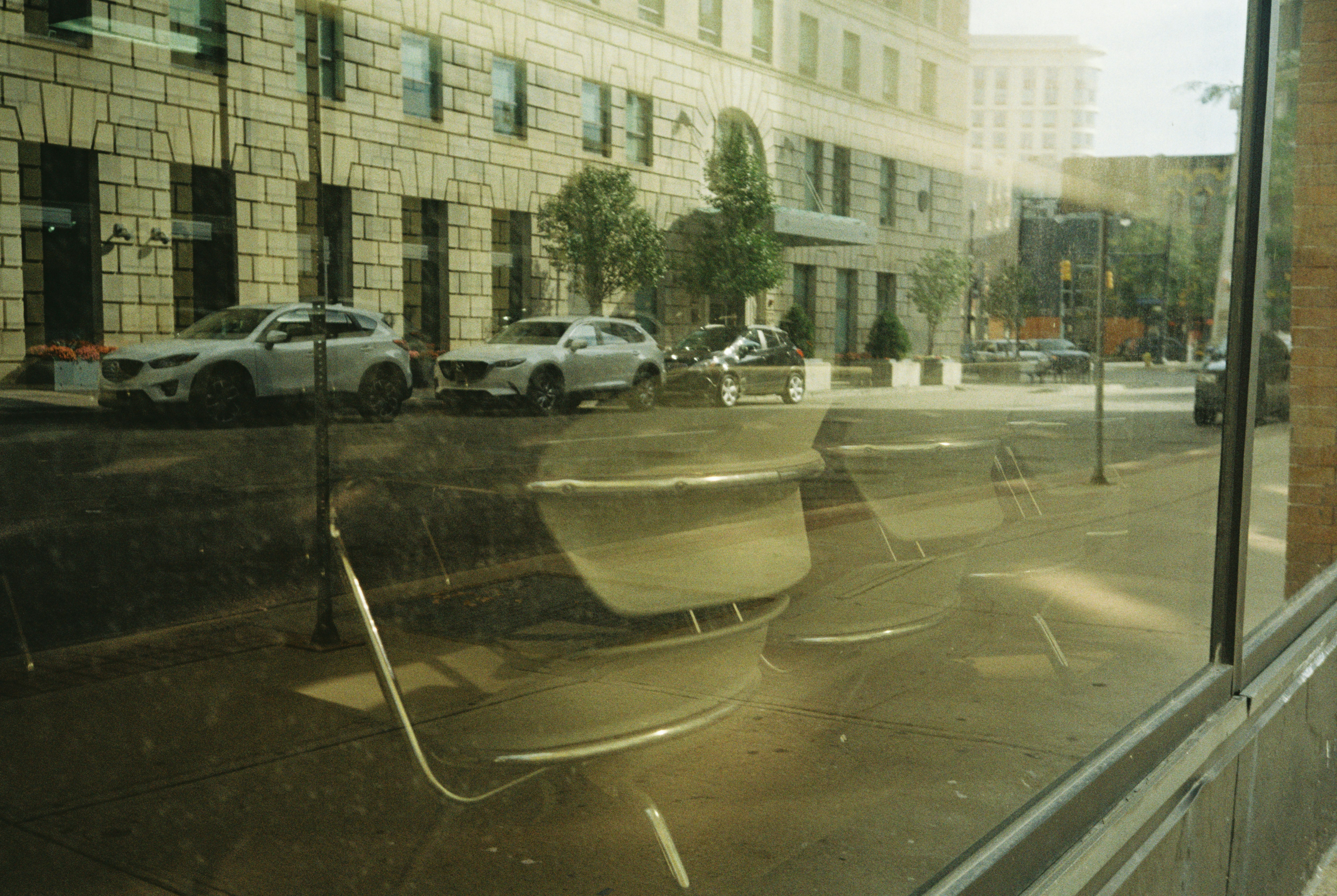 A view of a city street through a window photo – Free Street Image on ...