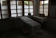 A serene clinic room with soft lighting and comfortable treatment beds, reflecting a professional post-operative care environment.