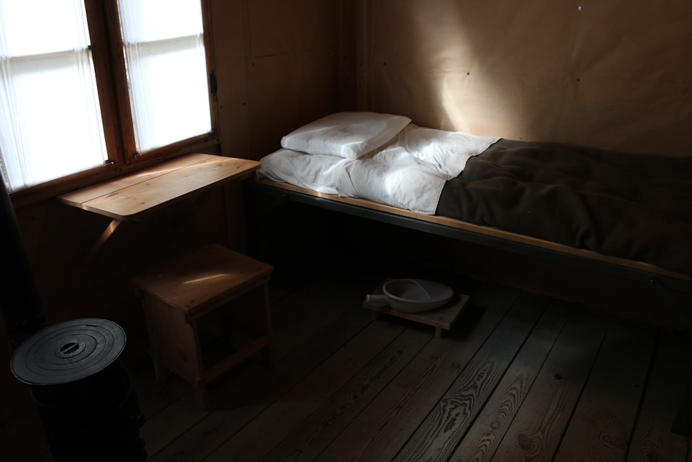 a bed sitting in a bedroom next to a window