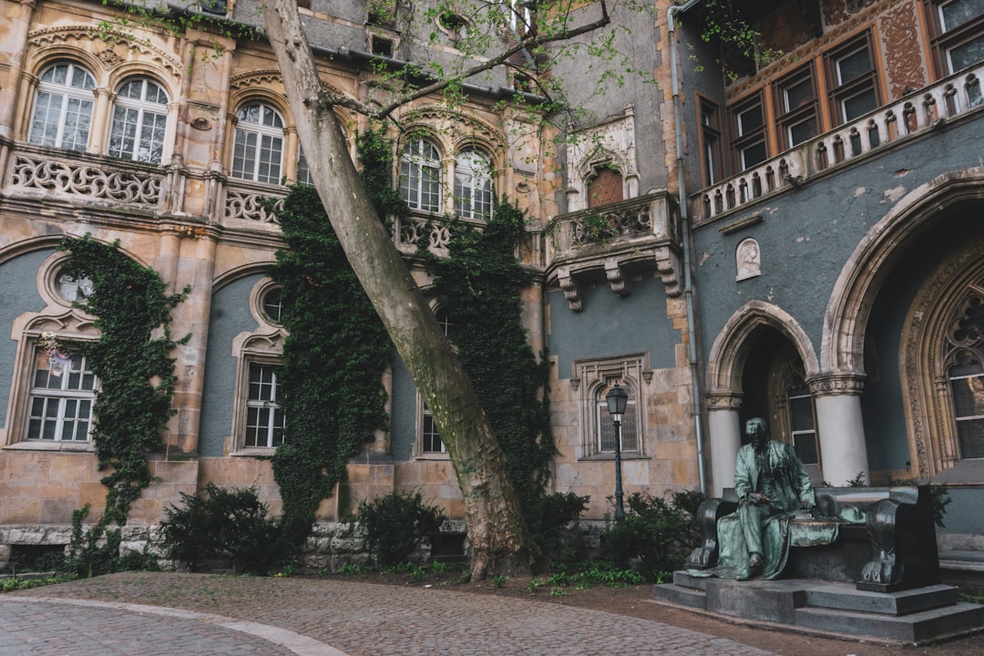 an old building with a statue in front of it,