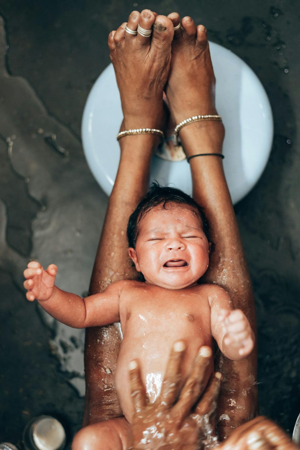 a woman holding a baby in her arms