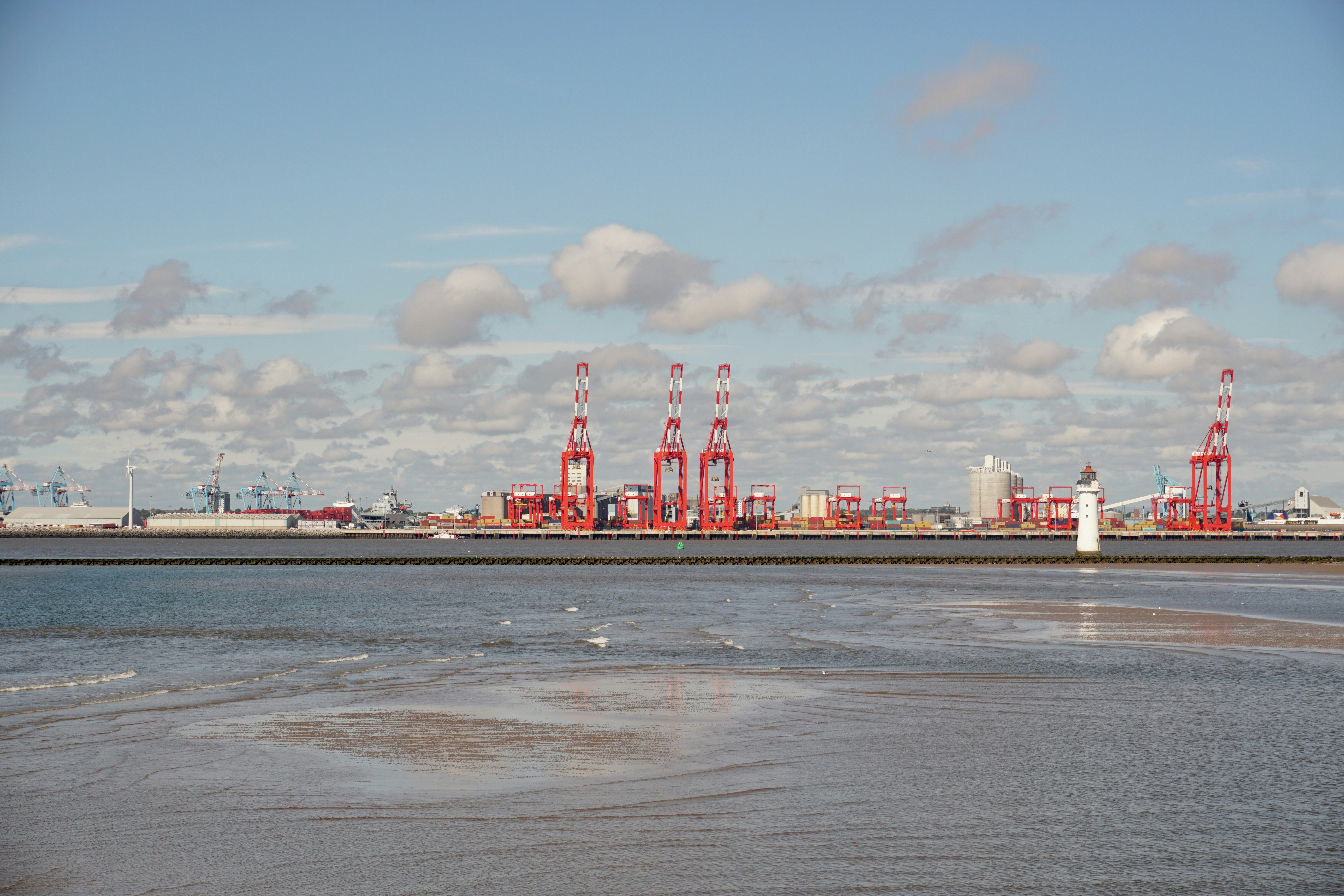 Dockside structures sit along the waterside at the Port of Liverpool. As seen from the opposite bank of the River Mersey.