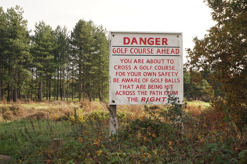 a sign warning of a golf course ahead