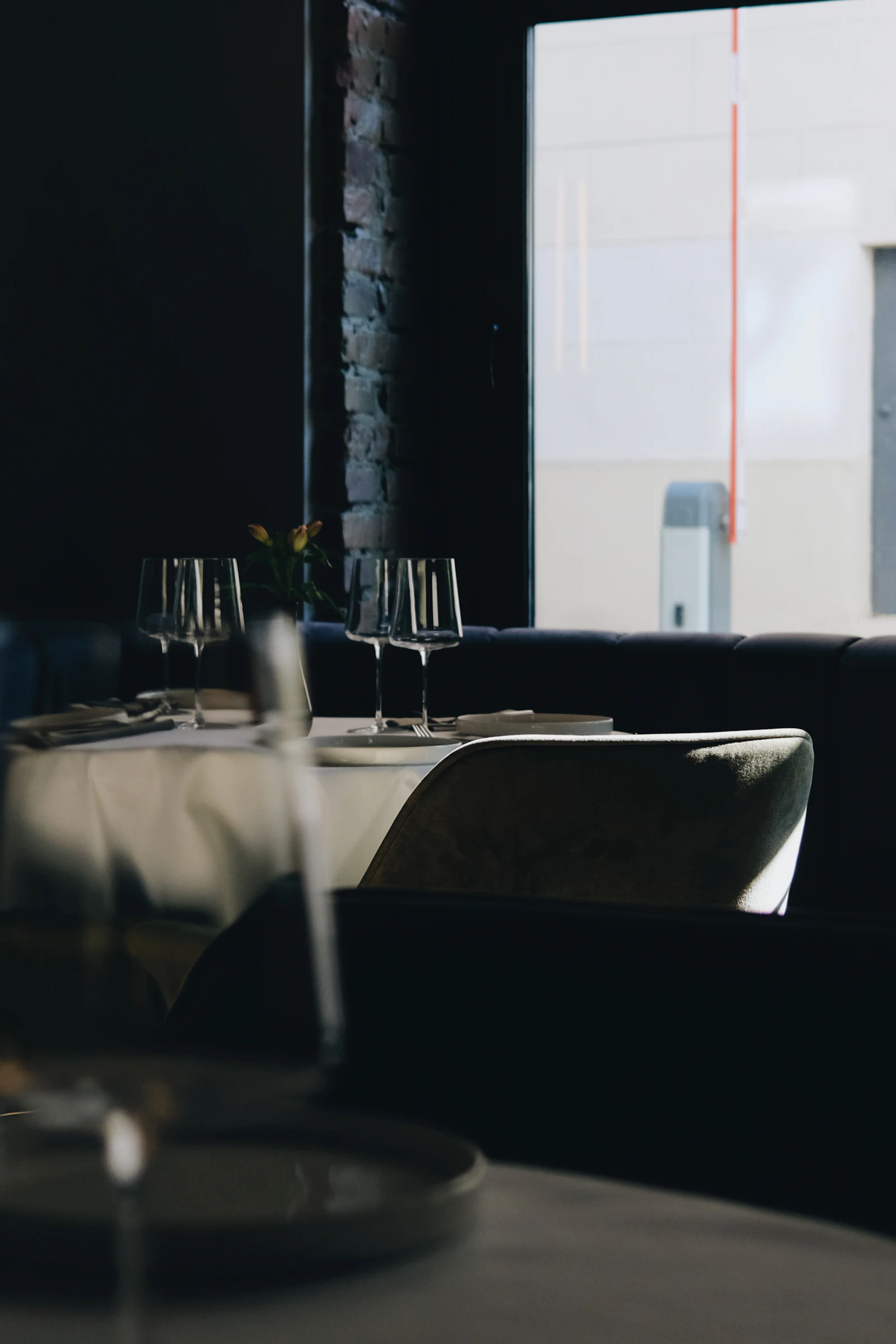 A dining room with a long table and tall windows
