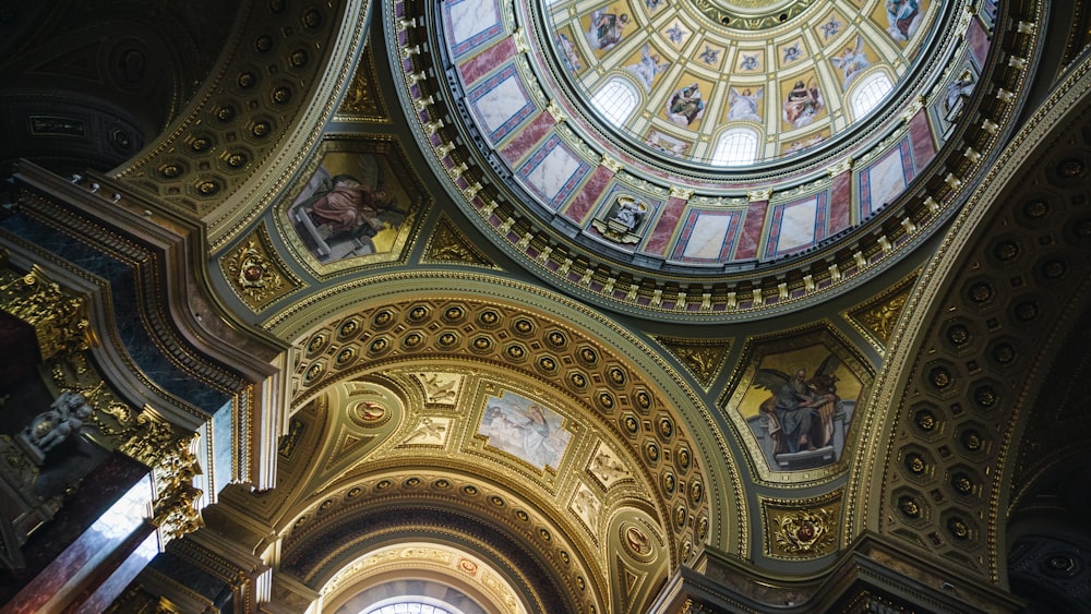 the ceiling of a church with a dome and paintings on it