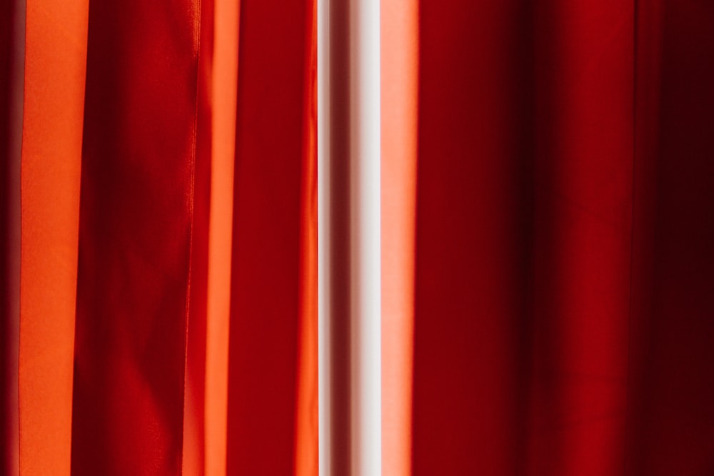 a close up of a red curtain in a room