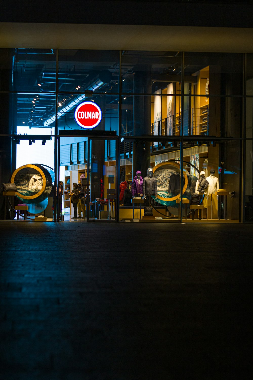 a store front at night with people standing outside