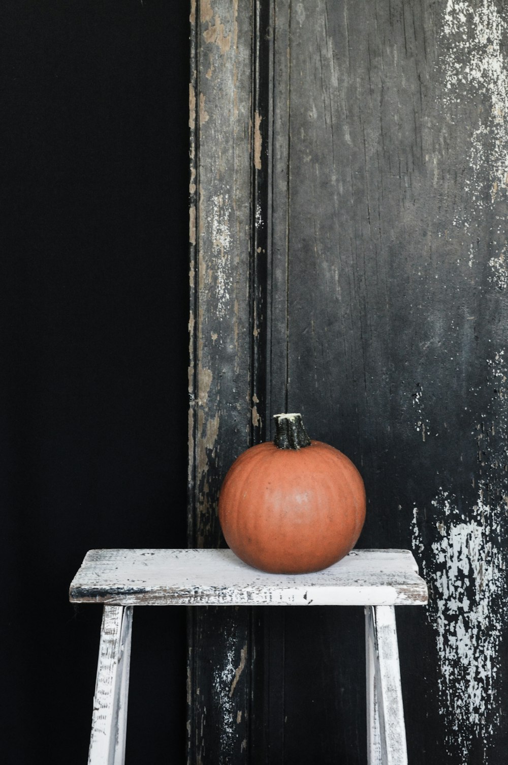 an orange pumpkin sitting on top of a white table