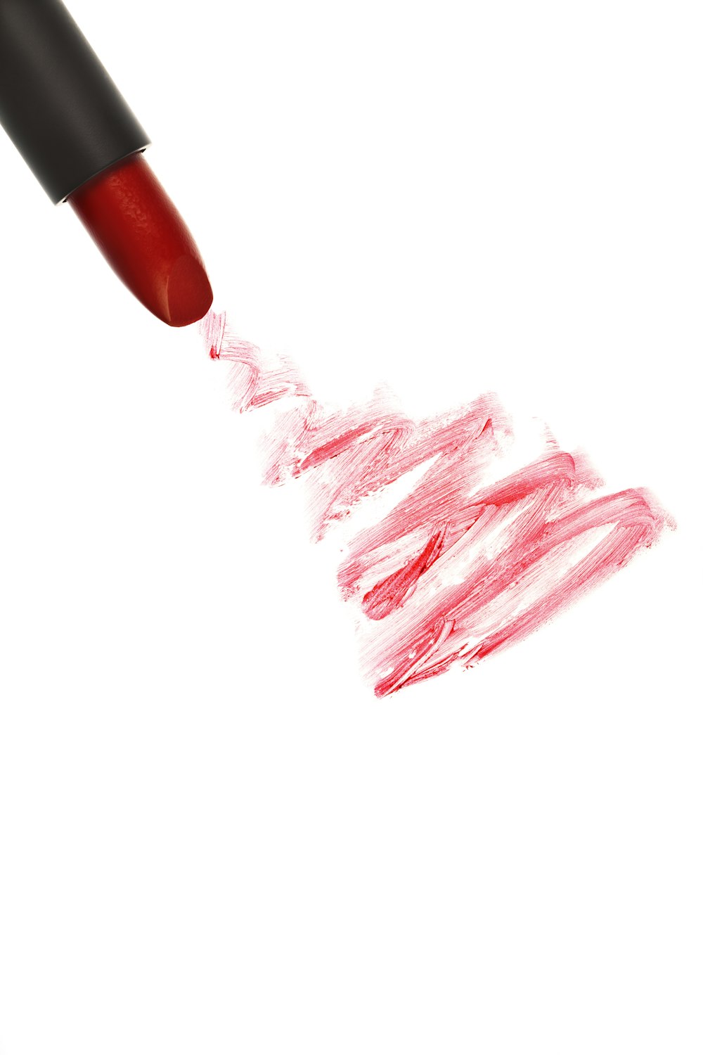 a close up of a red lipstick on a white background