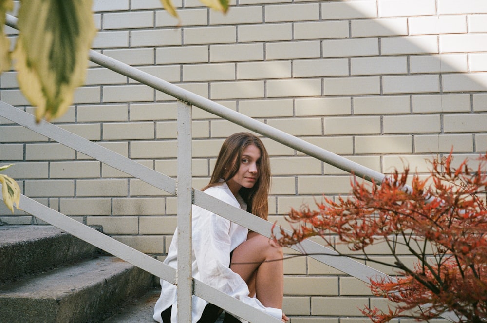 a woman sitting on the steps of a building