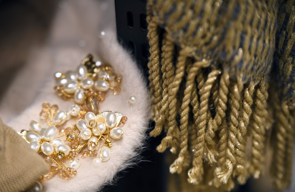 a close up of a pair of gloves with pearls