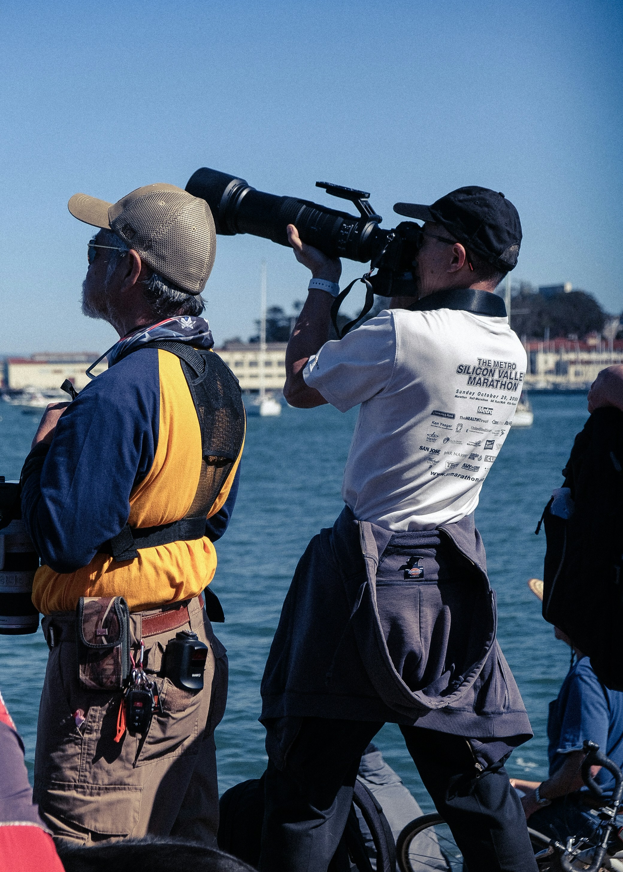 two men standing on a boat with a camera