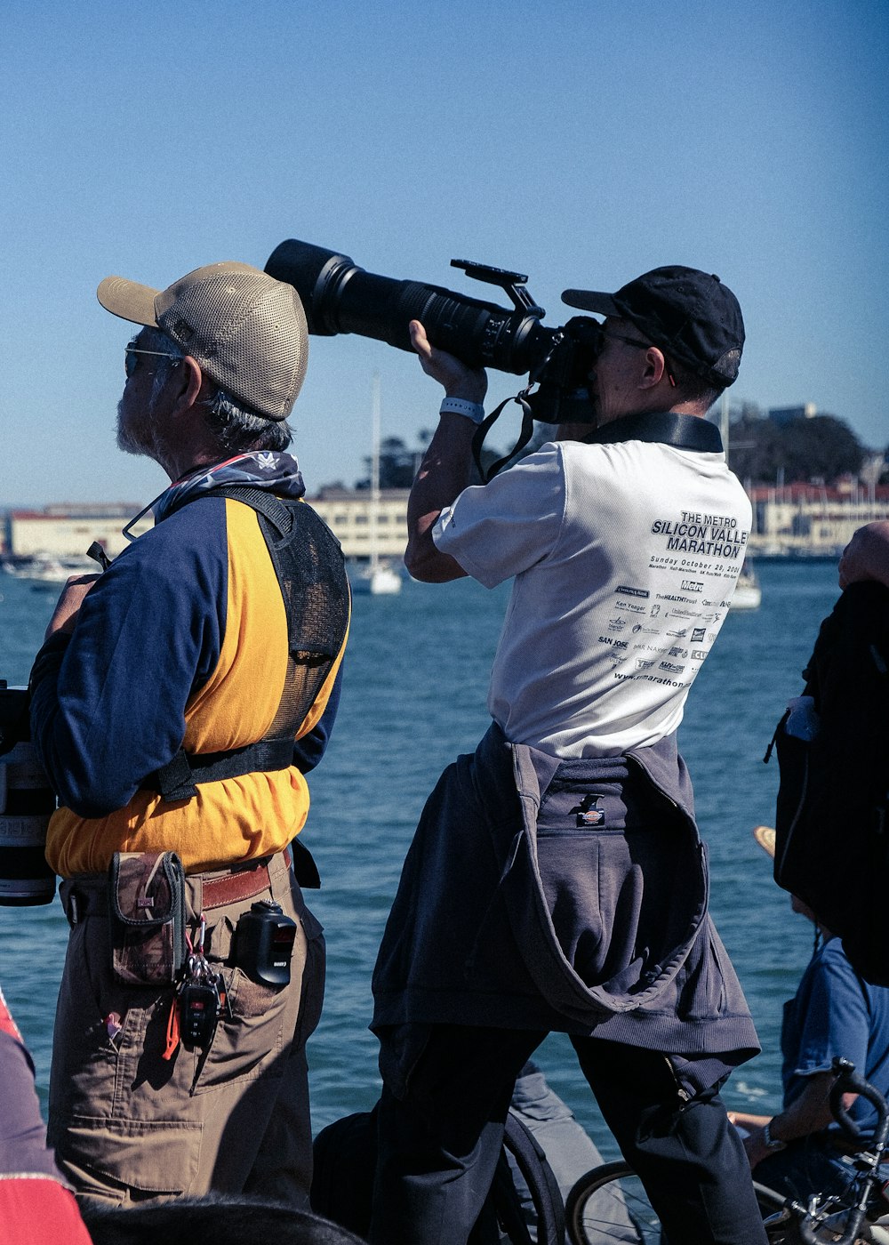 two men standing on a boat with a camera