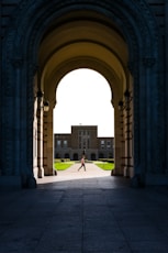 a person walking under an archway in a building