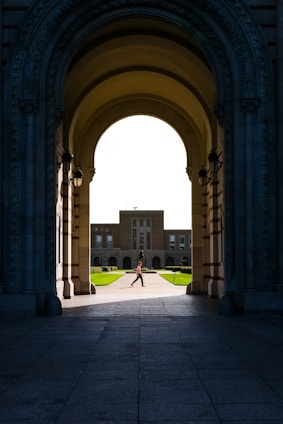 a person walking under an archway in a building