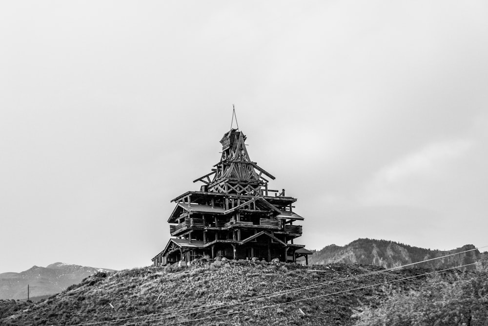 una estructura de madera muy alta sentada en la cima de una colina