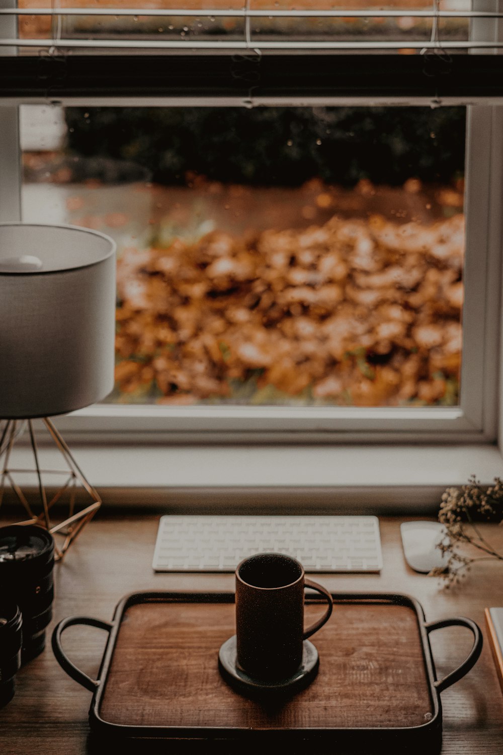 a cup of coffee sitting on top of a wooden tray