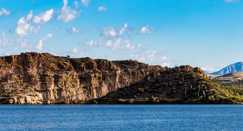 a large body of water with a mountain in the background