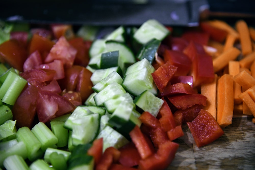 a close up of a cutting board with chopped vegetables